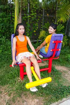 Asian Thai Girls with Exercise Machine in Public Park