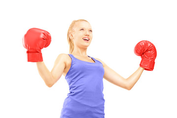 Female athlete wearing boxing gloves and gesturing happiness