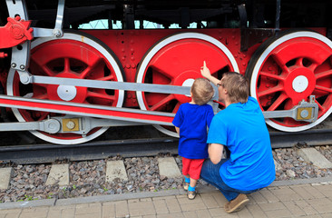 family looking at steam train