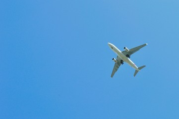 Large passenger airplane flying in the blue sky