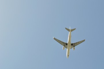 Large passenger airplane flying in the blue sky