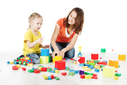 Mother and child playing blocks toys over white