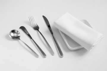 fork,spoon,knife ,dish and  tablecloth on white clothe table