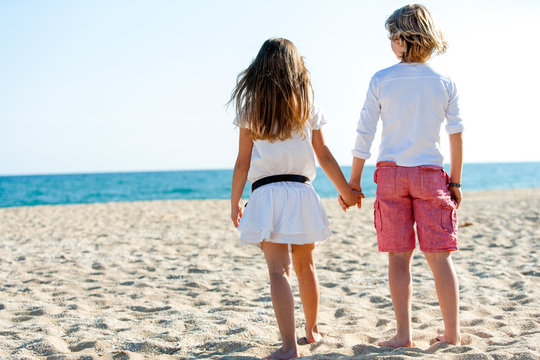 Boy and girl looking at sea.