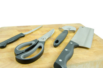 kitchen tools on chopping board on white