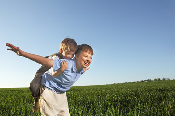 two brathers outdoors happy play