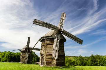 Fototapeta na wymiar Two old wooden windmills