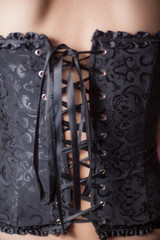 Close-up shot of woman in black corset