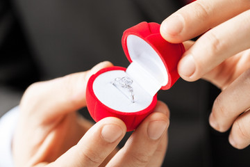 man with wedding ring and gift box