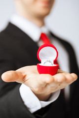 man with wedding ring and gift box