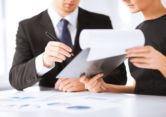businessman and businesswoman signing paper
