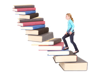 child climbing staircase of books