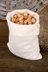 Beans in sack on wooden background