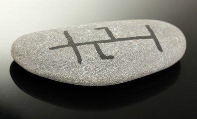 Fortune telling  with symbols on stone on black background