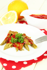 Asparagus on plate, on wooden background