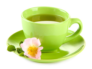 Cup of herbal tea with hip rose flower, isolated on white