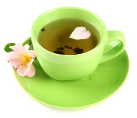 Cup of herbal tea with hip rose flower, isolated on white