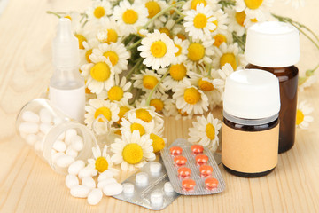 Medicine chamomile flowers on wooden table