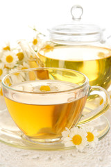 Cup of herbal tea with camomiles close up
