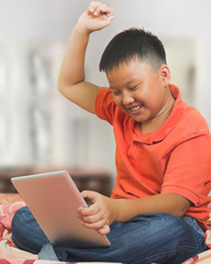 Young asian boy with a tablet computer