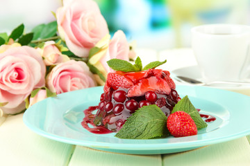 Tasty jelly dessert with fresh berries, on bright background