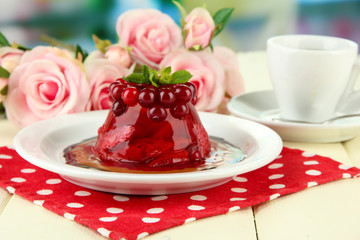 Tasty jelly dessert with fresh berries, on bright background