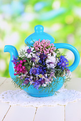 Beautiful bouquet in blue teapot