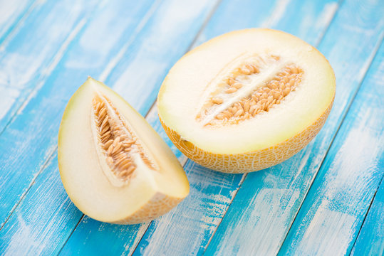 Sliced Galia melon on wooden boards, horizontal shot