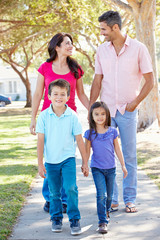 Family Walking Along Suburban Street
