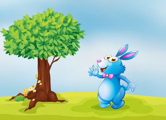 A blue bunny waving in front of a big tree