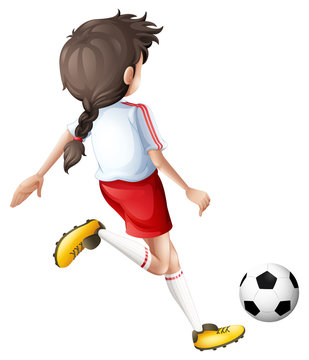 A girl kicking a soccer ball