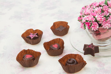 Chocolate Truffles with bouquet of pink roses in the coffee cup