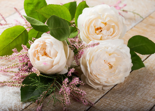 Fototapeta Pastel roses on wooden background