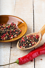 Mixed pepper on wooden background
