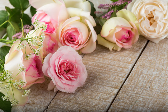 Fresh roses on wooden background