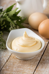 Mayonnaise in bowl on table