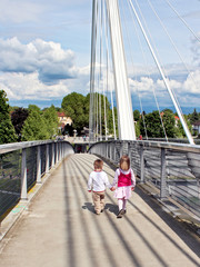cute children couple on bridge