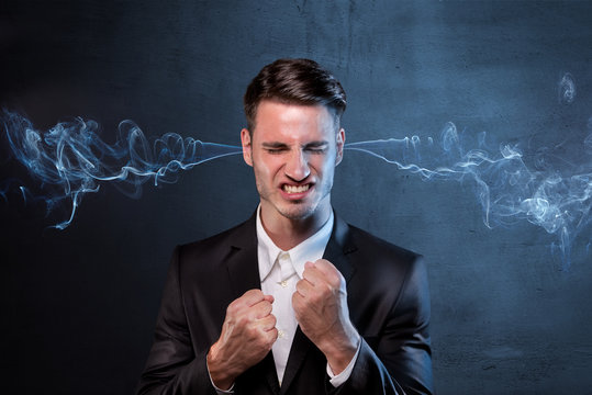 Businessman smoking with anger