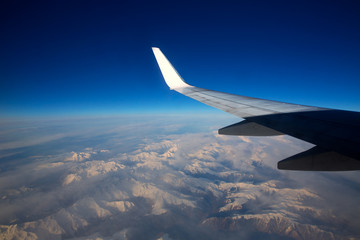 aircraft flying over snowed mountains of Pyrenees