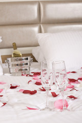 hotel room with big bed and red flowers