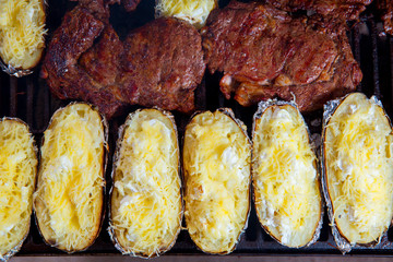 Barbecue grilled beef meat and prepared potatoes