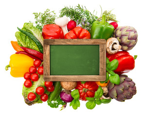 blackboard with fresh organic vegetables and herbs