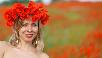 beauty woman in poppy field in white dress