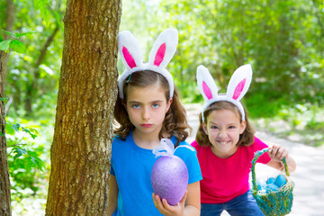 Easter girls playing on forest with bunny teeth gesture