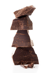Pieces of dark chocolate isolated on white background