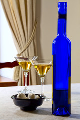 Sweets in a bowl, a bottle with wine