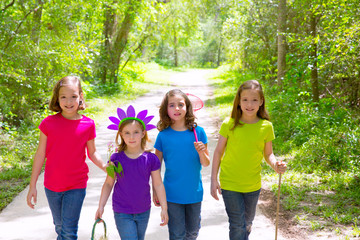 Friends and sister girls walking outdoor in forest track