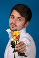 Man giving the red roses. Close up portrait.