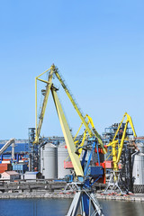 Fototapeta na wymiar Cargo crane and grain dryer in port Odessa, Ukraine