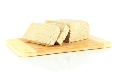 Tasty halva on cutting board isolated on white